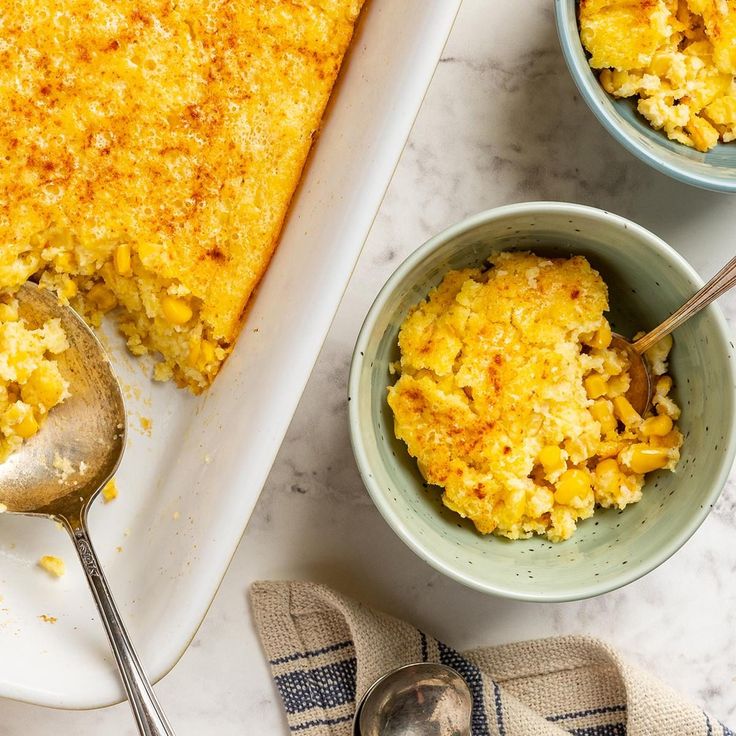 there is a casserole dish on the table with two bowls