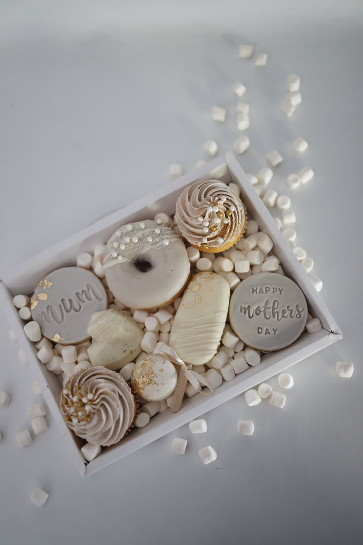 a box filled with lots of different types of donuts and marshmallows