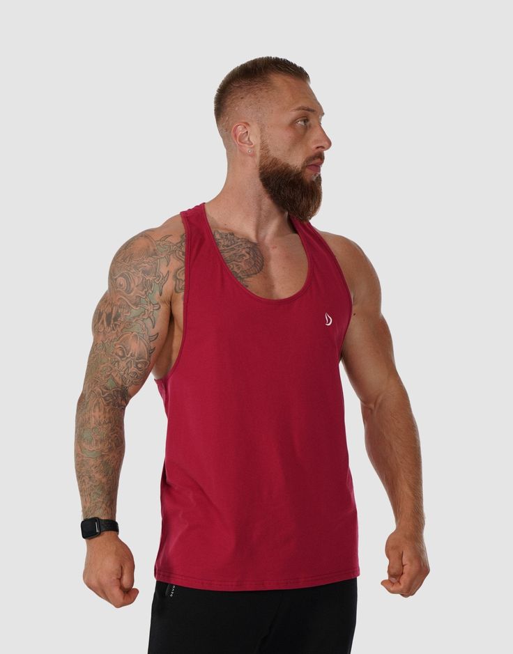 The ultimate workout companion for your lifting sessions. Crafted from 100% pure cotton, this stringer is designed with a relaxed, loose fit, offering freedom of movement comfort and breathability during your workouts. The soft cotton fabric feels gentle against the skin, reducing irritation and allowing you to focus solely on your performance. Its durable material promises long-lasting wear, while the comfortable fit makes it perfect for everyday training. Model: Straten is 6.1” and wears size Red Sweat-resistant Activewear For Workout, Red Racerback Activewear For Training, Red Racerback Athleisure Activewear, T-back Tank Top For Sports, Red Moisture-wicking Racerback Activewear, Breathable Muscle Tee For Summer Training, Solid T-back Tank Top For Sports, Red Stretch Tank Top For Gym, Summer Breathable Muscle Tee For Training