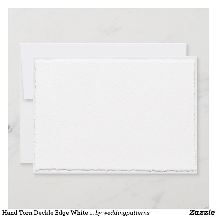 a white card with torn paper on it