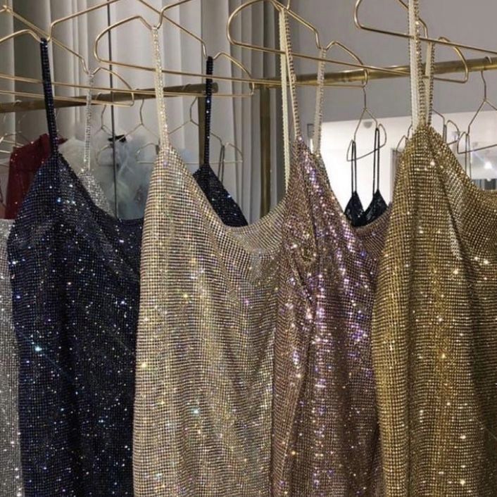 three different types of sequins hanging on a clothes rack in front of a window