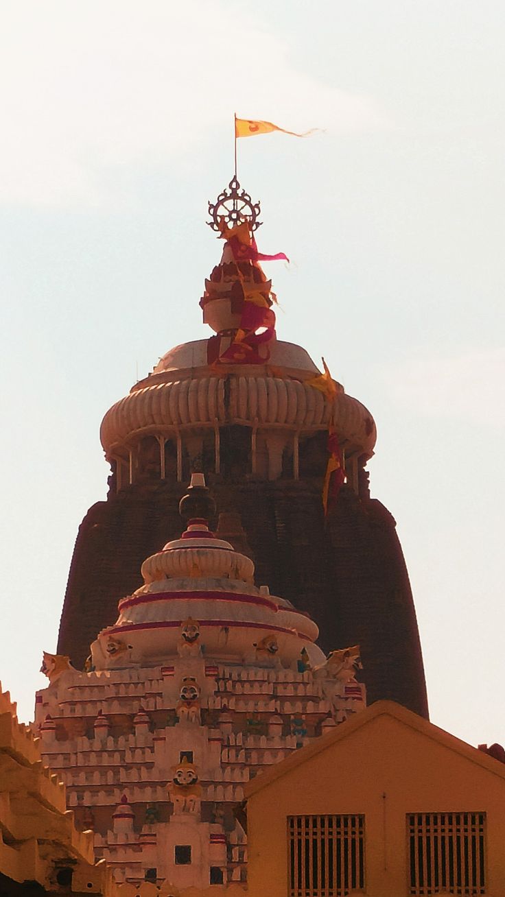 the top of a building with a statue on it