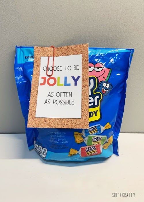 a close up of a bag of candy with a sign attached to it that says, choose to be jolly as often as possible