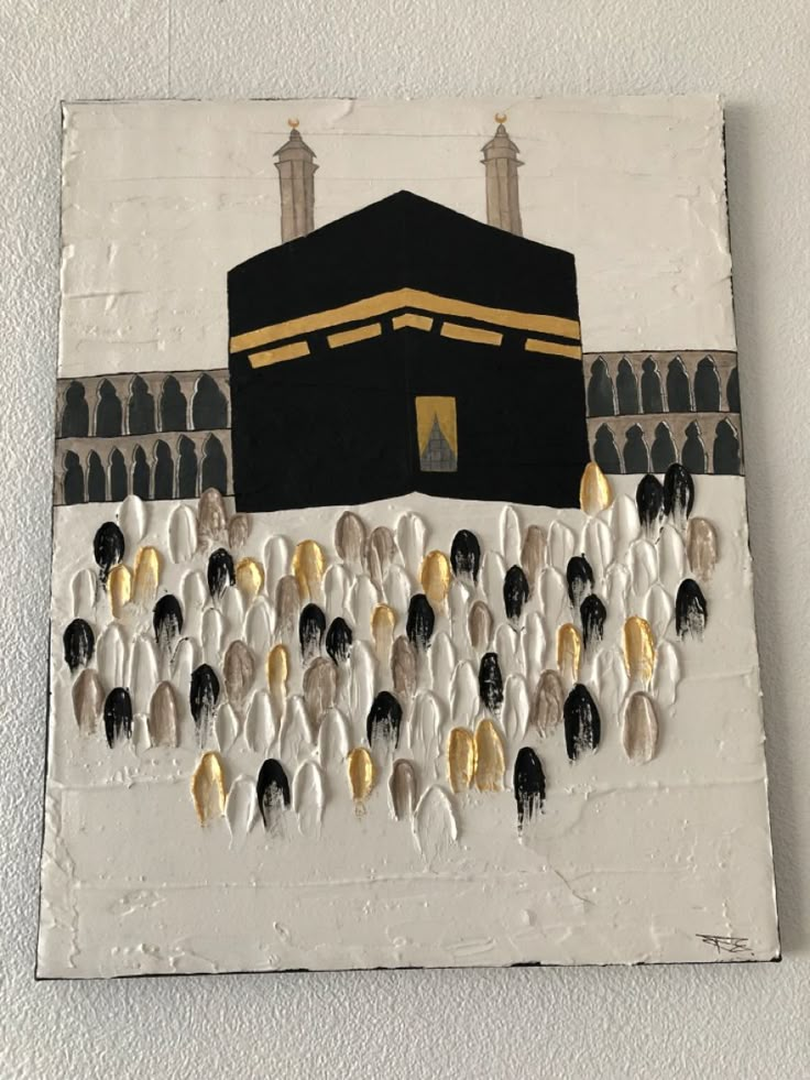 an art piece is hanging on the wall in front of a building with gold and black accents