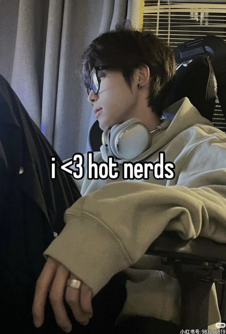 a person sitting in a chair with headphones on and the words i > 3 hot nerds