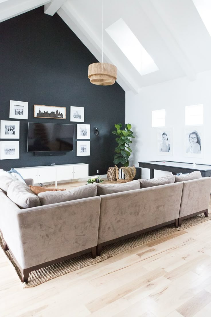 a living room filled with furniture and a flat screen tv mounted to the wall above it