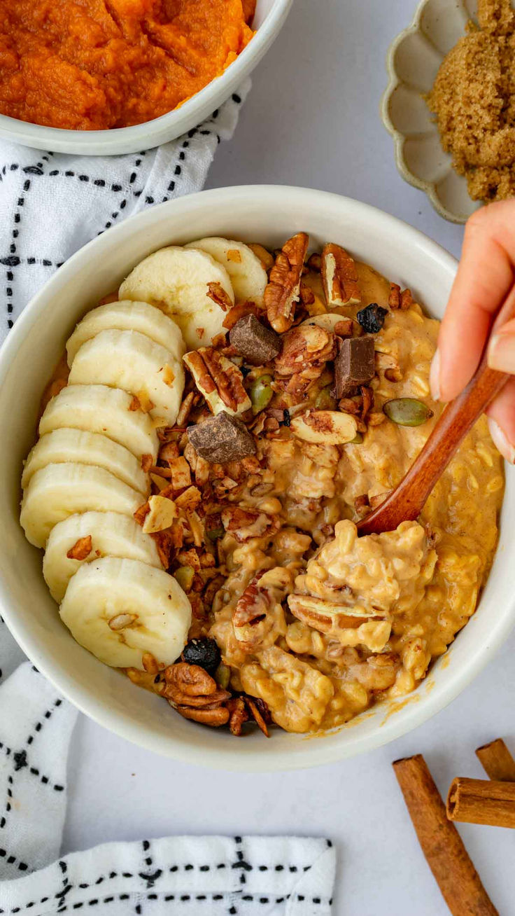 a bowl filled with oatmeal, bananas and cinnamon on top of a table