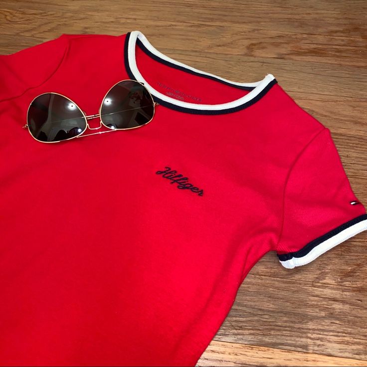 Never Worn, In Great Condition. Red And Navy Colors, With Navy Cursive Logo On The Front. Bundle Three Items For A 15% Discount! Tommy Hilfiger Stretch Top For Spring, Tommy Hilfiger Casual Fitted Tops, Tommy Hilfiger Stretch Tops For Summer, Fitted Tommy Hilfiger Tops For Summer, Tommy Hilfiger Short Sleeve Tops For Spring, Trendy Tommy Hilfiger Tops For Spring, Spring Stretch Top By Tommy Hilfiger, Casual Stretch Tops By Tommy Hilfiger, Tommy Hilfiger Spring Tops With Short Sleeves