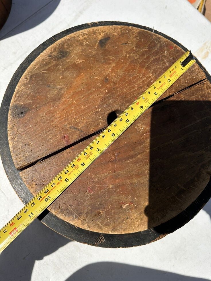 a wooden table with a measuring tape on it