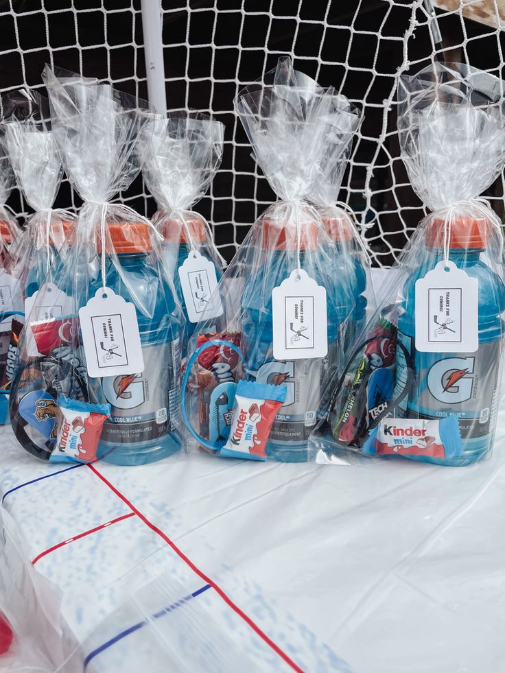 plastic bags filled with toys sitting on top of a table next to a goalie net