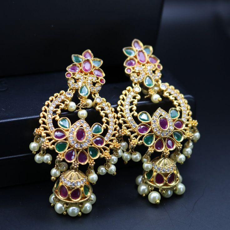 "Exquisite Chandbali earrings handcrafted in brass, adorned with sparkling CZ or shimmering pearls. Timeless elegance for any celebration, from birthdays and anniversaries to festival nights.\" Features: sparkling CZ or shimmering pearls Lightweight and elegant Can be paired with any dress, kurti, or saree Material: Brass Ready to ship from California Free US standard shipping Ready to ship CARE INSTRUCTIONS: 1) Please keep your Jewelry away from moisture and We advise you to do the following things to keep them lasts longer: 2) Please do not wear the jewelry at the time of workout to avoid accidental damage, while using hairspray and perfume. 3) Keep your jewelry away from chemicals. 4) Store jewelries separately, Different kinds of metal react together. To avoid this, store the jewelry i Fashion Collection Inspiration, Chandbali Earrings, Pearl Drop, Timeless Elegance, Fashion Collection, Bridal Jewelry, Sparkle