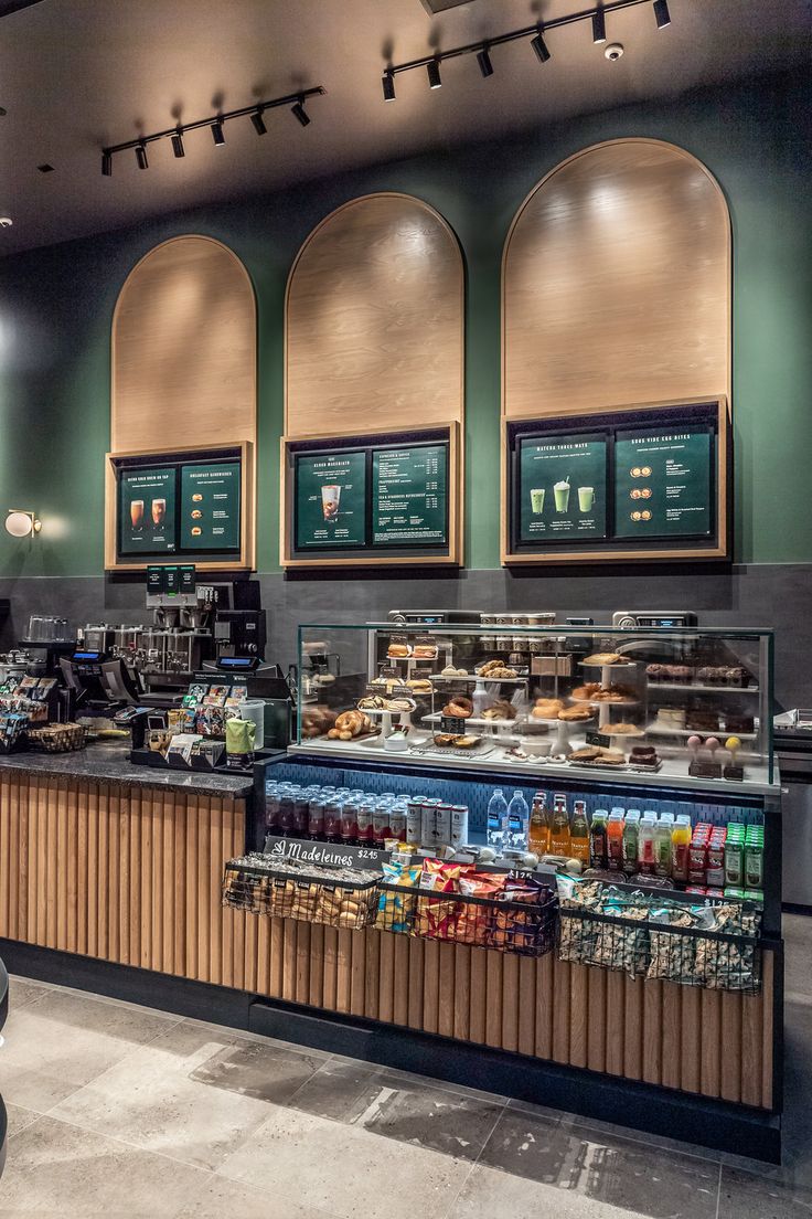 the inside of a fast food restaurant with menus on the wall and tables in front of it