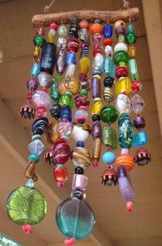 a wind chime hanging from the ceiling with lots of colorful glass beads on it