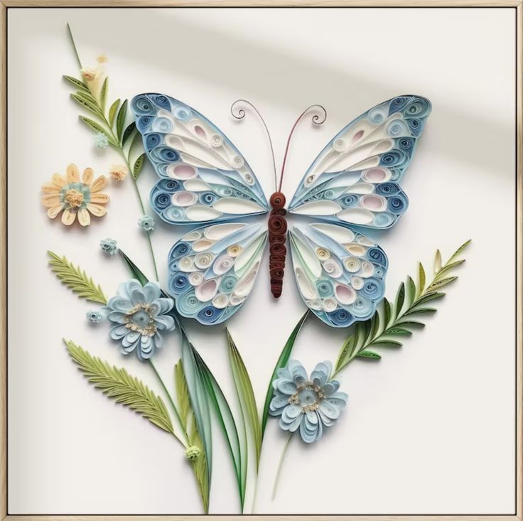 a paper butterfly with flowers and leaves on it's wings is featured in a frame