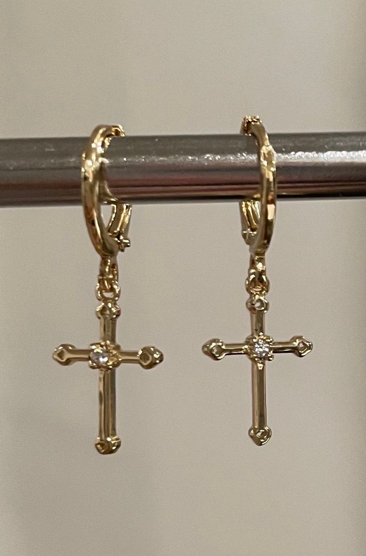 Beautiful dainty cross dangling earrings. 18K gold plated brass. It is of great importance to me that I make jewelry for my customers that I, myself, wear every day. Each jewelry piece is handmade by me personally with love and care. Each item is crafted to the highest quality and made to exceed the expectations of my customers. My jewelry is designed to you to love and wear no matter what the occasion at an affordable price. Jewelry is packaged in a velvet pouch and wrapped in tissue paper whic Cross Gold Jewelry, Hrh Collection Jewellery, Gold Cross Jewelry, Gold Metal Cross Jewelry, Cute Cross Earrings, Cross Gold Earrings, Small Cross Earrings, Cross Earrings Aesthetic, Cross Dangle Earrings