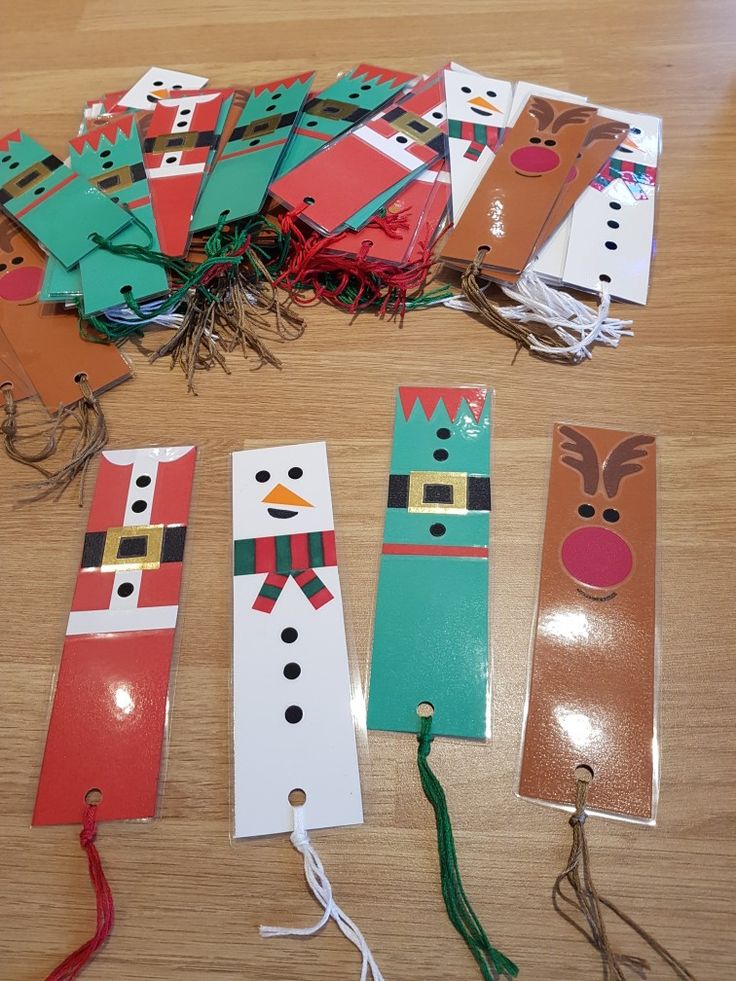 some paper snowmen and reindeers are on the floor next to other christmas decorations