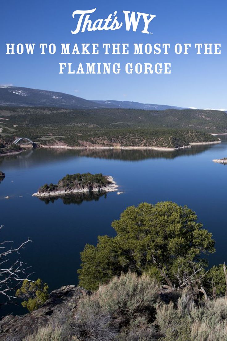 a lake surrounded by mountains with the words that's why how to make the most of the flaming gorge