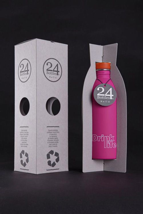 a pink bottle sitting inside of a cardboard box next to a white box with the number 24 on it