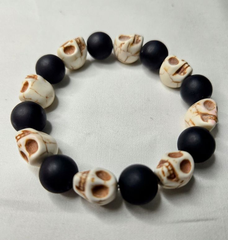 a black and white bracelet with skulls on it