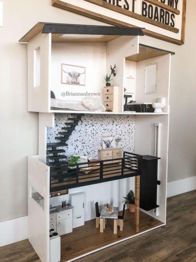 a doll house with stairs and furniture inside