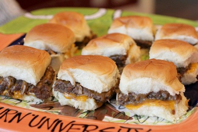 mini cheeseburger sliders on a plate with the word university written on it