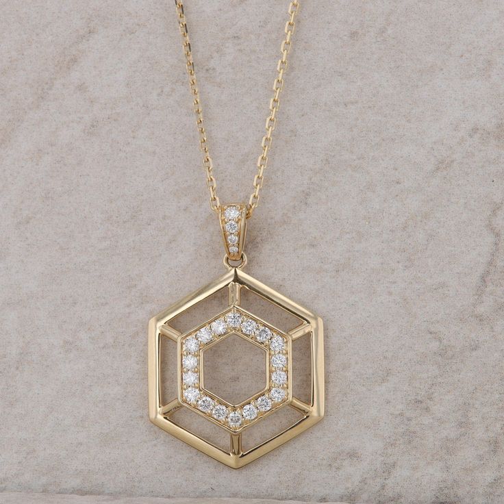 This ladies 14k yellow gold necklace has twenty-two round brilliant diamonds that are prong set into the first/smaller hexagon. The diamonds in the bail and in the hexagon measure approx 0.50ctw. The diamond cut cable chain is 0.08mm and has a jump ring at 16" and the lobster clasp meets at 18", so it can be worn at either length. The necklace weighs 6.55 grams and the pendant measures 32.5mm in height, including the bail. It has a lobster clasp. Condition: New *All items are thoroughly inspecte Fine Jewelry With Hexagon Brilliant Cut, Fine Jewelry Hexagon Brilliant Cut, Hexagon Brilliant Cut Fine Jewelry, Formal Hexagon Single Cut Diamond Jewelry, Hexagon Diamond Jewelry With Brilliant Cut, Hexagon Brilliant Cut Diamond Jewelry, Octagon Diamond Cut Necklace, Fine Jewelry Diamond Necklace With Octagon Shape, Fine Jewelry Diamond Octagon Necklace