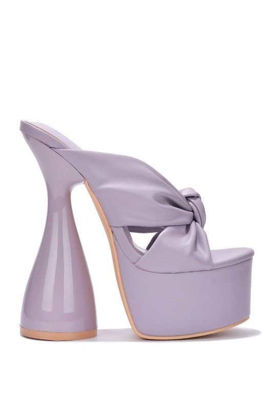 This Heeled Sandals are the must-haves every dance floor needs, with a tie knot upper. statement heel and an open toe. Show em' what you got! Open Toe Patent Sole Statement Platform Heel Heel Height: 7" Approx. Lilac Heels, Shoes Reference, Cone Heels, High Heels For Women, Heeled Mule, Mule Shoes, Prom Heels, Style 2023, Hour Glass