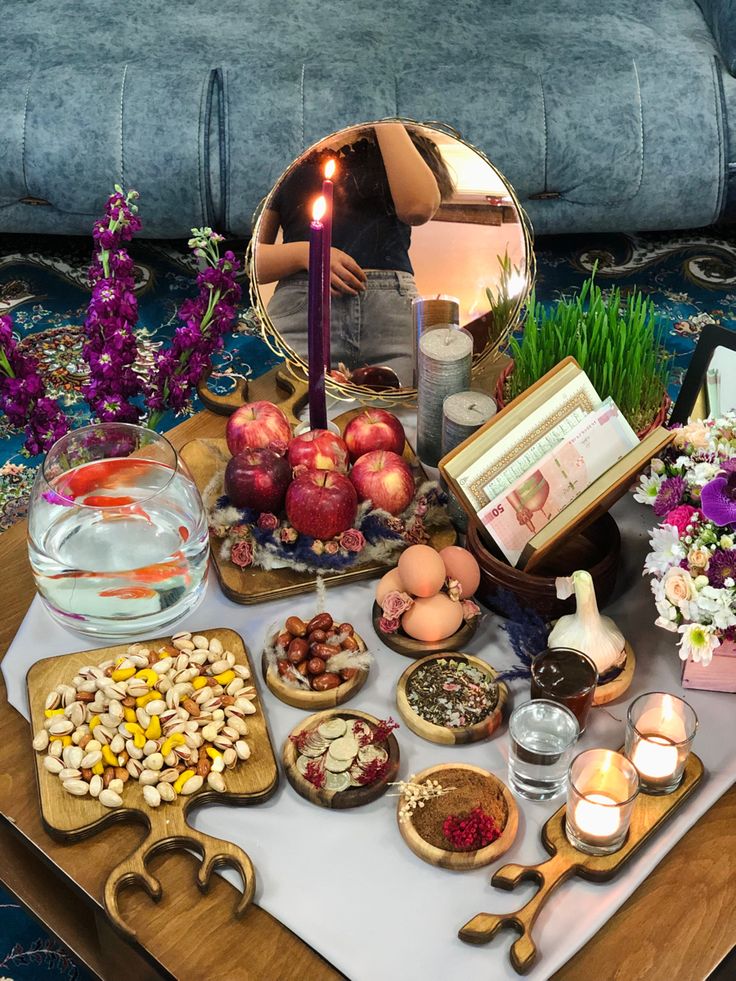 a table topped with lots of food and candles