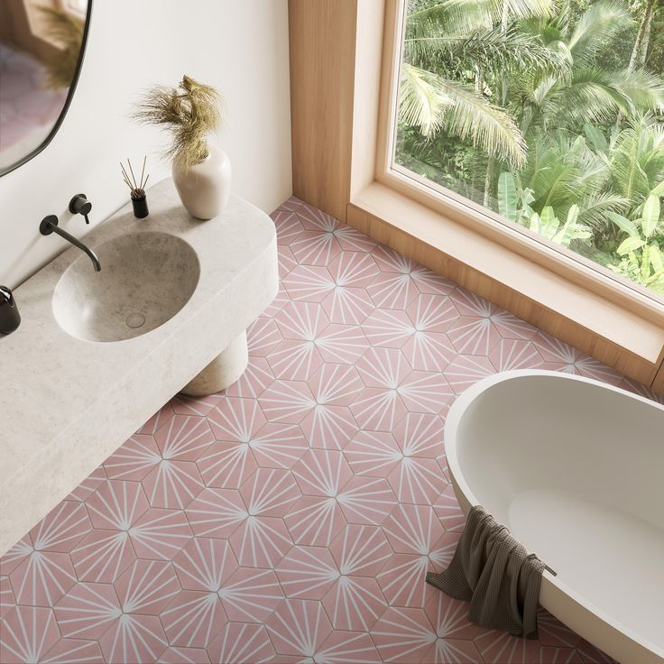 a bath room with a sink and a tub in front of a large window next to a palm tree