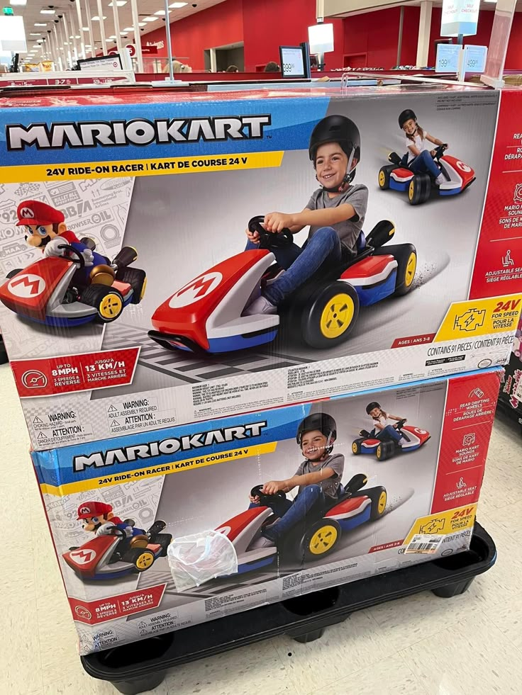 two children's go kart toys are on display in the store for sale