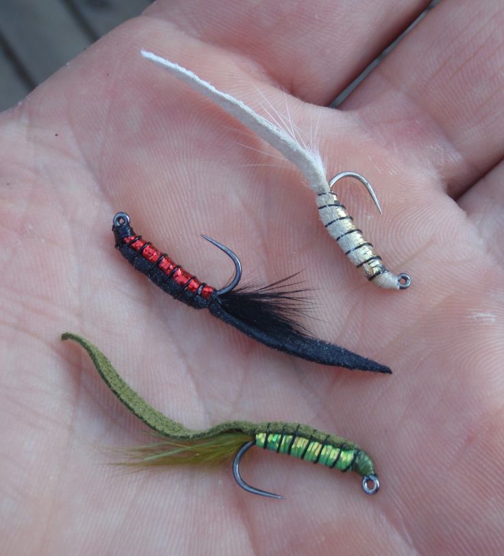 three different types of fishing lures in someone's hand