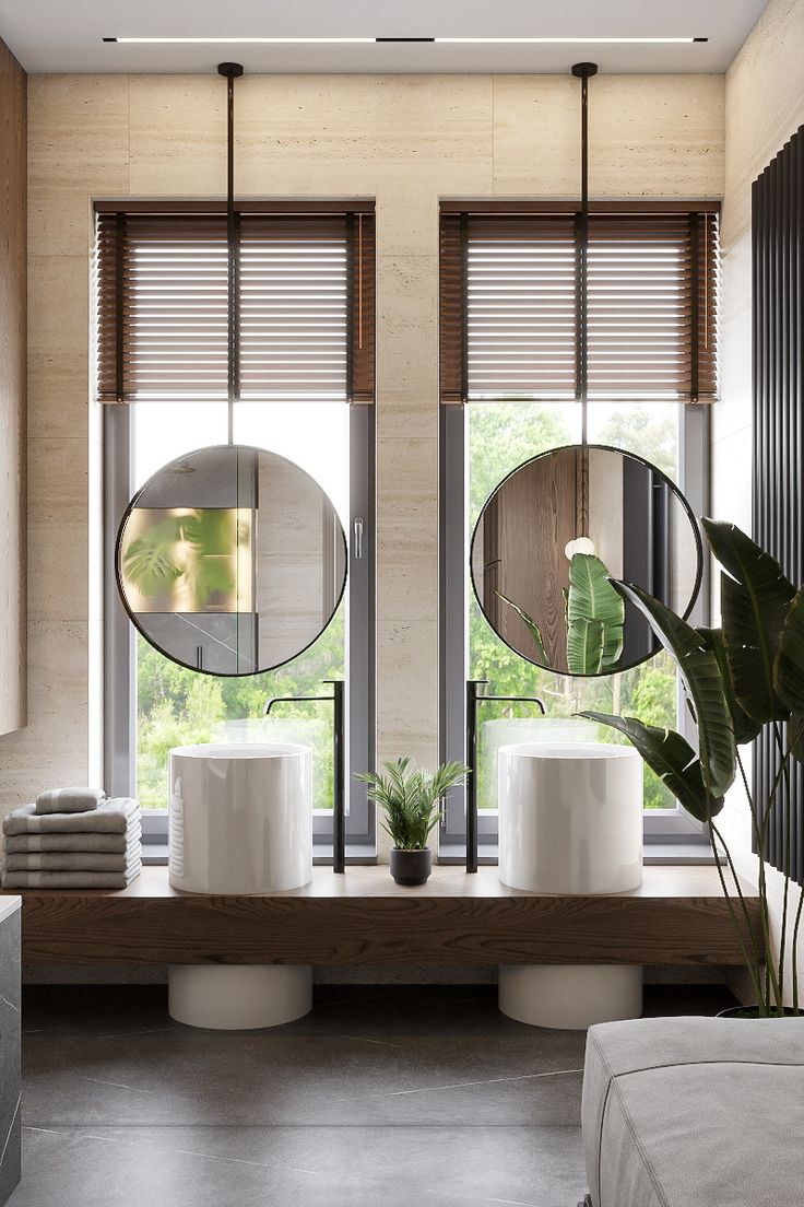 a bathroom with two round mirrors on the wall and three planters in front of it