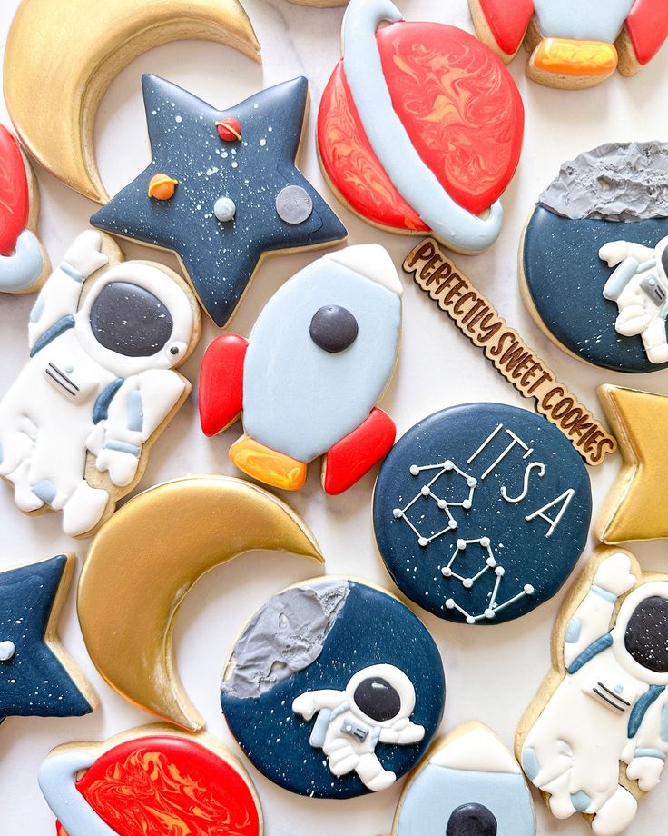 some cookies are decorated with space related items