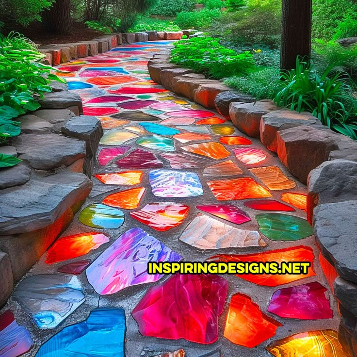 a pathway made out of stained glass in the woods