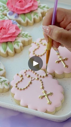 someone is decorating cookies with icing and crayons on the trays