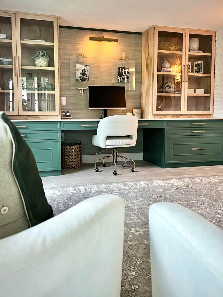 a living room filled with furniture and green cabinets