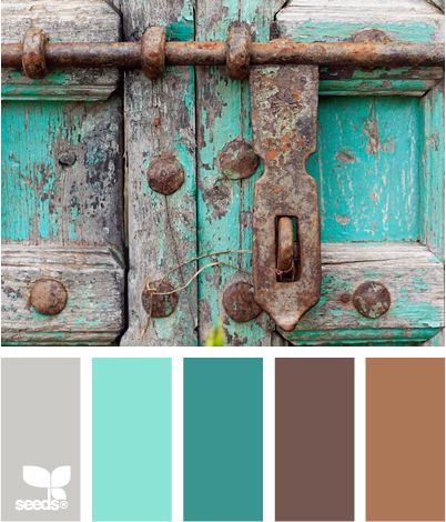 an old wooden door with rusted metal latches and color swatches on it