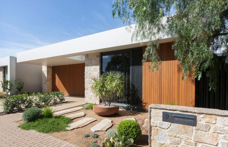 a modern house with stone and wood accents