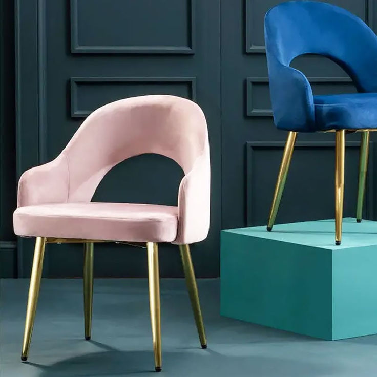 two different colored chairs sitting next to each other in front of a blue and pink wall