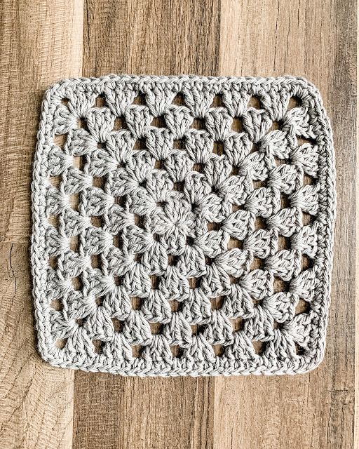 a crocheted dishcloth sitting on top of a wooden table