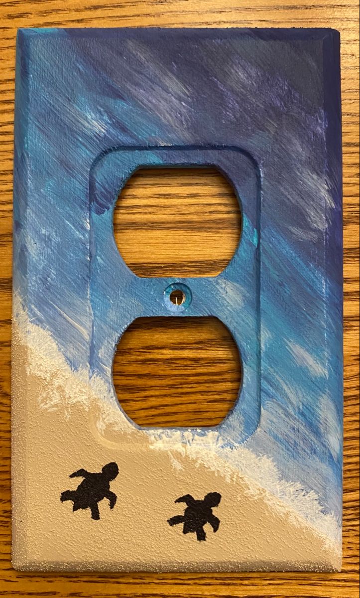 a light switch cover with two turtles painted on it