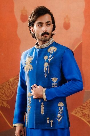 Navy blue bundi with gulmohar, sehra, baug taj scattered embroidered motifs. Paired with an inner embroidered kurta and pant. - Aza Fashions Blue Sherwani With Gota Work For Festivals, Festive Blue Sherwani With Gota Work, Blue Bandhgala With Zari Work For Navratri, Ceremonial Bandhgala With Gota Work For Diwali, Traditional Blue Bandhgala With Resham Embroidery, Ceremonial Nehru Jacket With Gota Work For Eid, Blue Sherwani With Gota Work For Eid, Blue Cutdana Sherwani For Transitional Season, Traditional Blue Bandhgala With Naqshi