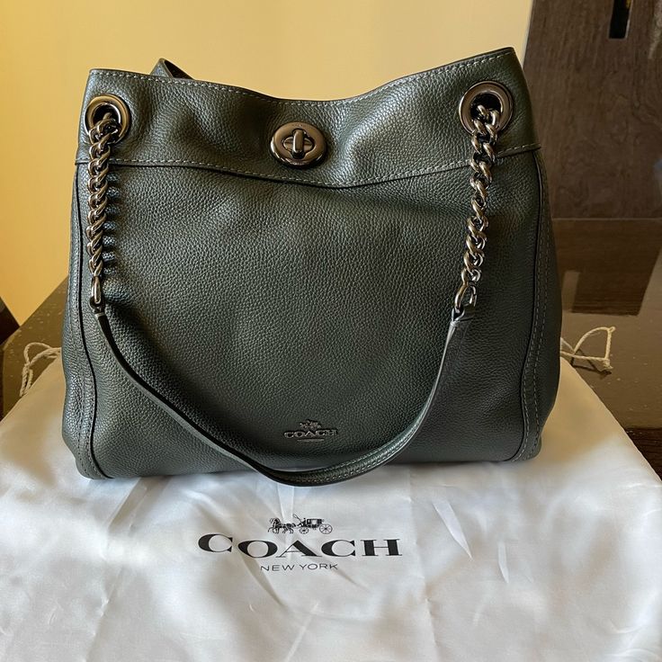 Brand New. Never Worn. Grayish Green Color. Will Come With Dust Bag. Coach Green Shoulder Bag With Gold-tone Hardware, Coach Shoulder Bag With Silver-tone Hardware For Daily Use, Coach Zip Top Tote, Green Coach Bags With Silver-tone Hardware, Coach Blue Shoulder Bag With Silver-tone Hardware, Coach Brown Shoulder Bag With Silver-tone Hardware, Grayish Green, Canvas Leather Bag, Vintage Coach Bags