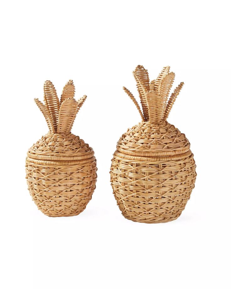 two wicker pineapple baskets sitting side by side on a white background, one is empty and the other has no lid