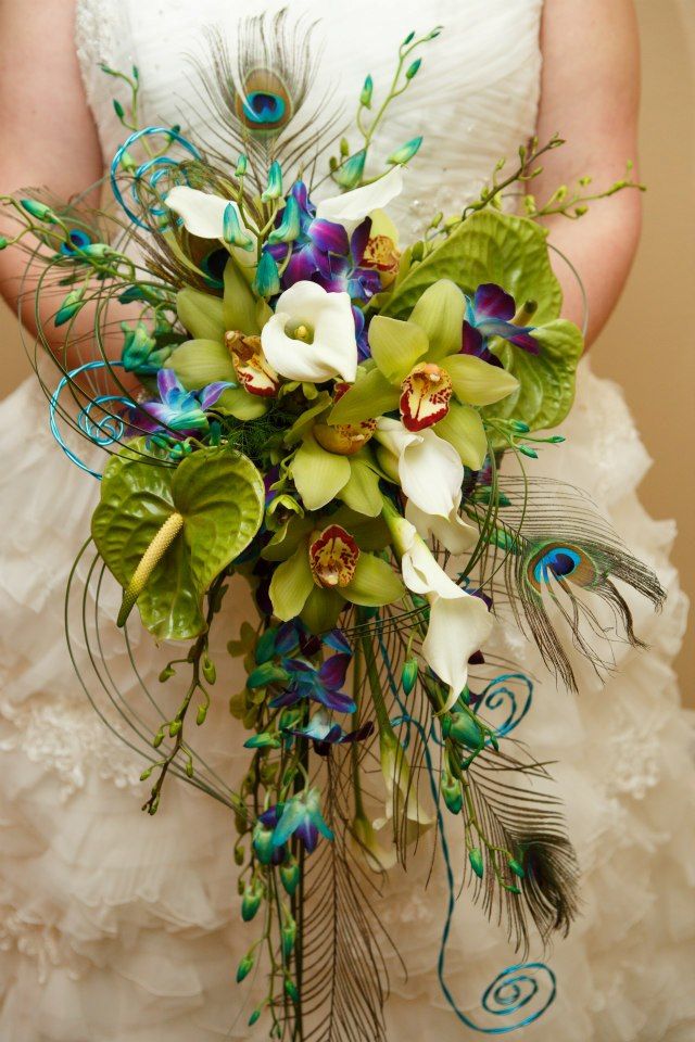 a bridal bouquet with peacock feathers and flowers