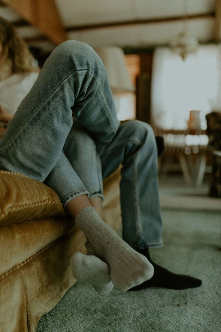 a person sitting on a couch with their feet up