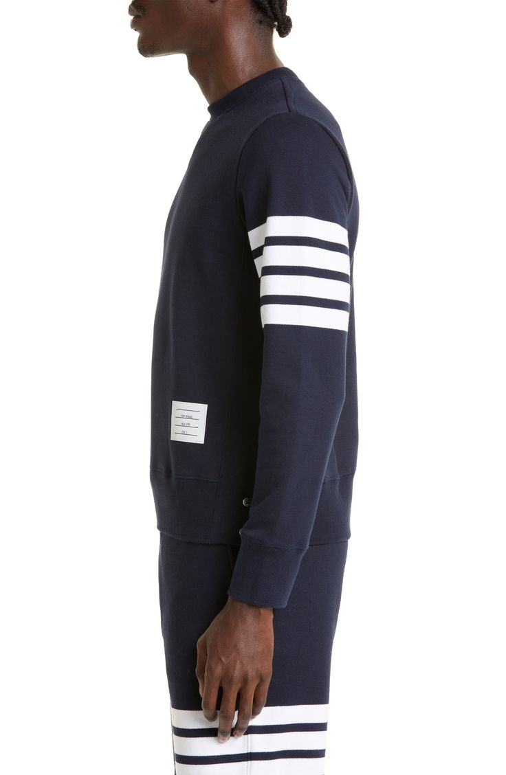 A quartet of thick stripes bands one arm of a well-appointed cotton sweatshirt replete with dapper details like a signature logo patch and a buttoned split hem. 25" length (size 2) Side button closure Crewneck Long sleeves with ribbed cuffs 100% cotton Dry clean Made in Japan Classic Long Sleeve Sweater With Contrast Stripes, Classic Navy Sweatshirt With Ribbed Cuffs, Casual Long Sleeve Sweatshirt With Signature Stripes, Cotton Sweatshirt With Contrast Stripes And Crew Neck, Casual Sweatshirt With Signature Stripes And Crew Neck, Cotton Crew Neck Sweatshirt With Contrast Stripes, Cotton Crew Neck Sweatshirt With Striped Cuffs, Cotton Striped Sweatshirt With Striped Cuffs, Varsity Long Sleeve Sweatshirt With Contrast Stripes