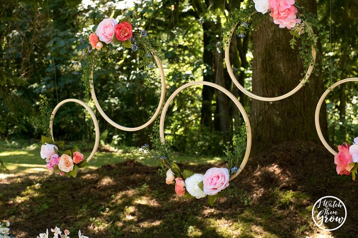 the wedding arch is decorated with pink and white flowers