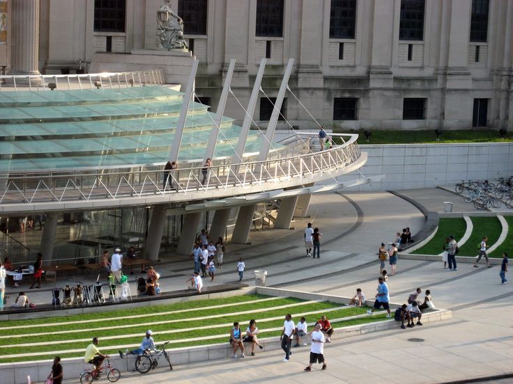 many people are walking around in front of a building