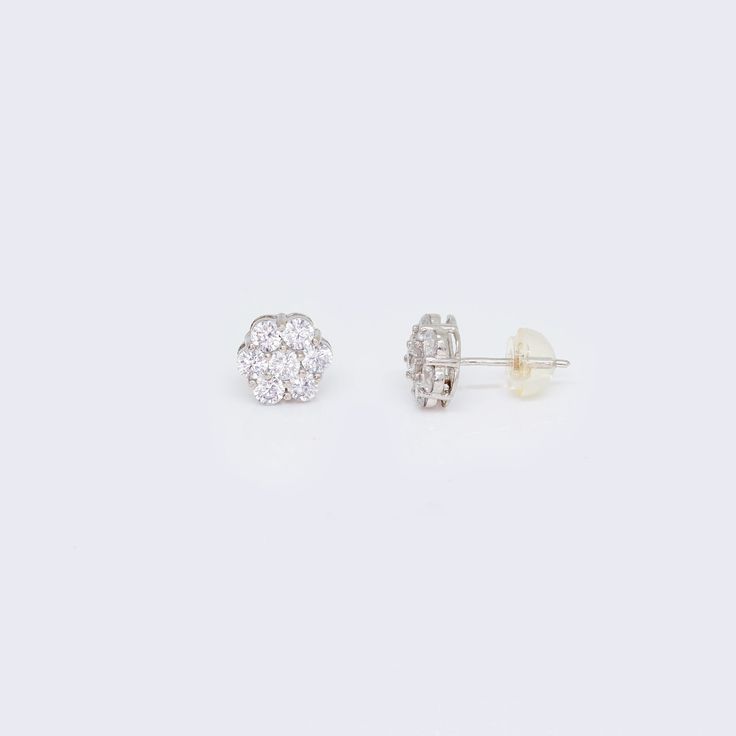 These 14K CZ Cluster Flower Stud Earrings are a stunning addition to any jewelry collection. Made with high-quality 14K white gold, these earrings are both durable and elegant. The intricate cluster flower design is adorned with sparkling cubic zirconia stones, adding a touch of glamour to any outfit. These earrings are perfect for any occasion, whether it's a formal event or a casual day out. The 14K CZ Cluster Flower Stud Earrings are a must-have for anyone who loves classic and timeless jewel Elegant Diamond Flower Shaped Earrings, Cubic Zirconia Bracelet, Cubic Zirconia Necklace, Flower Stud Earrings, Cubic Zirconia Earrings, Flower Stud, Cubic Zirconia Rings, Cz Earrings, Zirconia Earrings